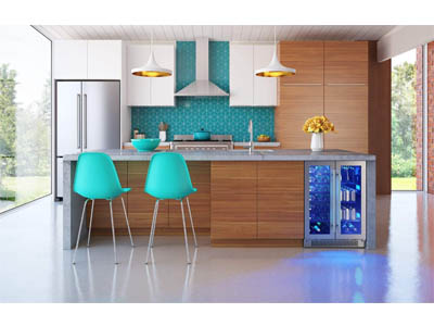 photo of a modern kitchen with the Zephyr Brisas 21-Bottle French Door Wine Fridge built under tge grey counter. two green plastic chairs stand at the counter.